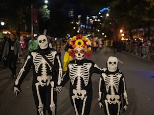 caption: Halloween revelers dressed in costumes march in New York City's 48th annual Greenwich Village Halloween Parade, Sunday, Oct. 31, 2021, in New York.