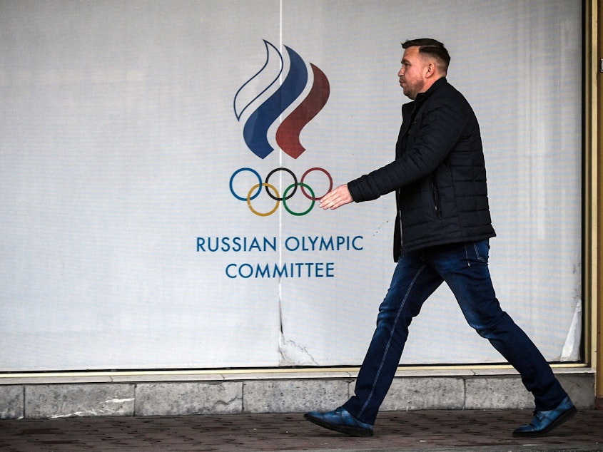 caption: The World Anti-Doping Agency has banned Russia from major events for the next four years, including the 2020 Tokyo Olympics and 2022 Beijing Winter Olympics. Here, a man walks in front of the Russian Olympic Committee headquarters in Moscow on Monday.