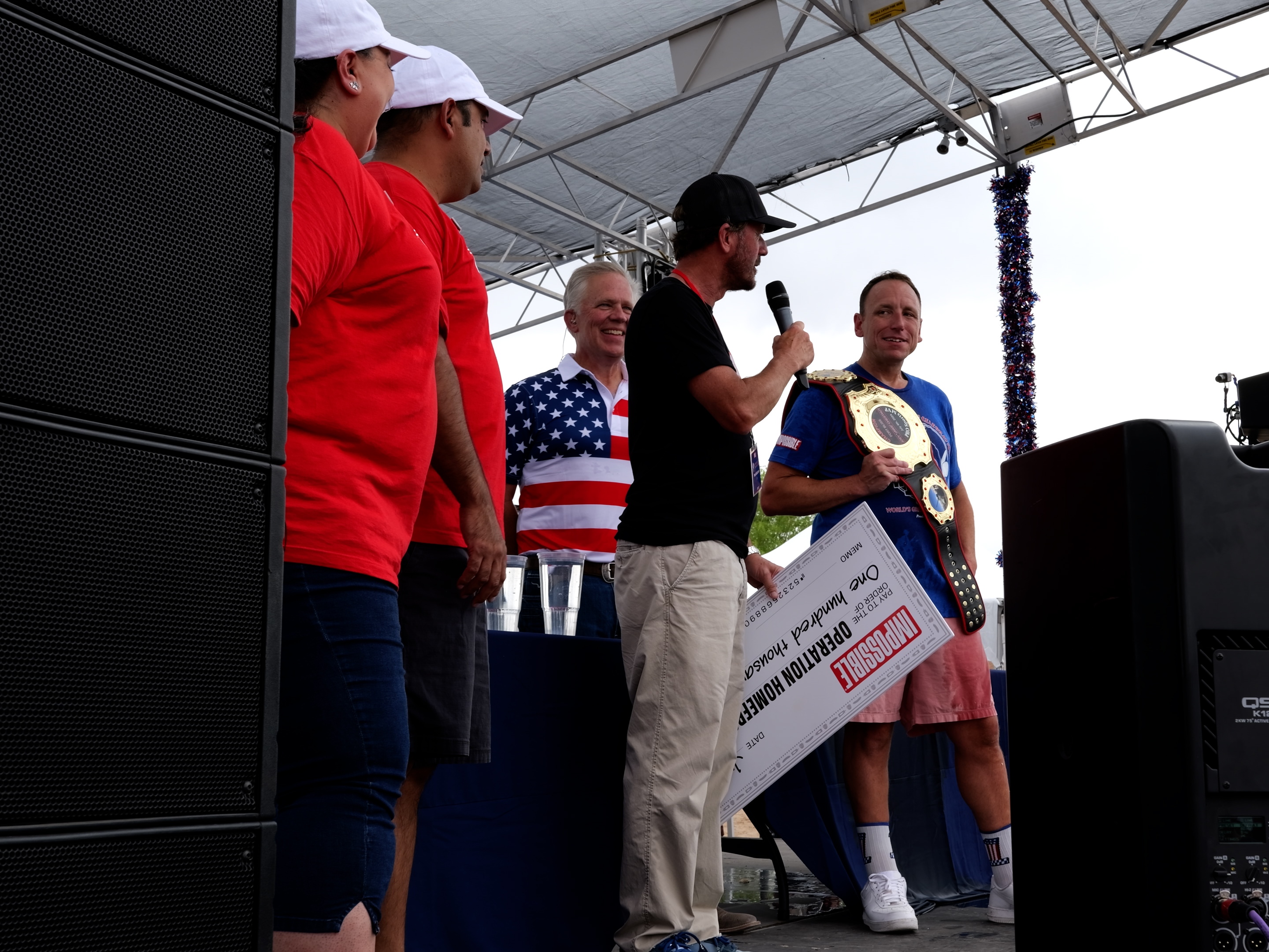 caption: Joey Chestnut (right) won a hot dog-eating contest against soldiers at Fort Bliss in El Paso, Texas, on Thursday, with Impossible Foods pledging to donate $1,000 in support of military families for each hot dog downed. 