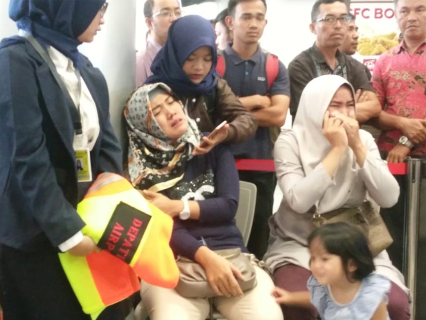 caption: Relatives of passengers of Lion Air flight JT610 that crashed into the sea, cry at Depati Amir Airport in Pangkal Pinang, Indonesia, Monday.