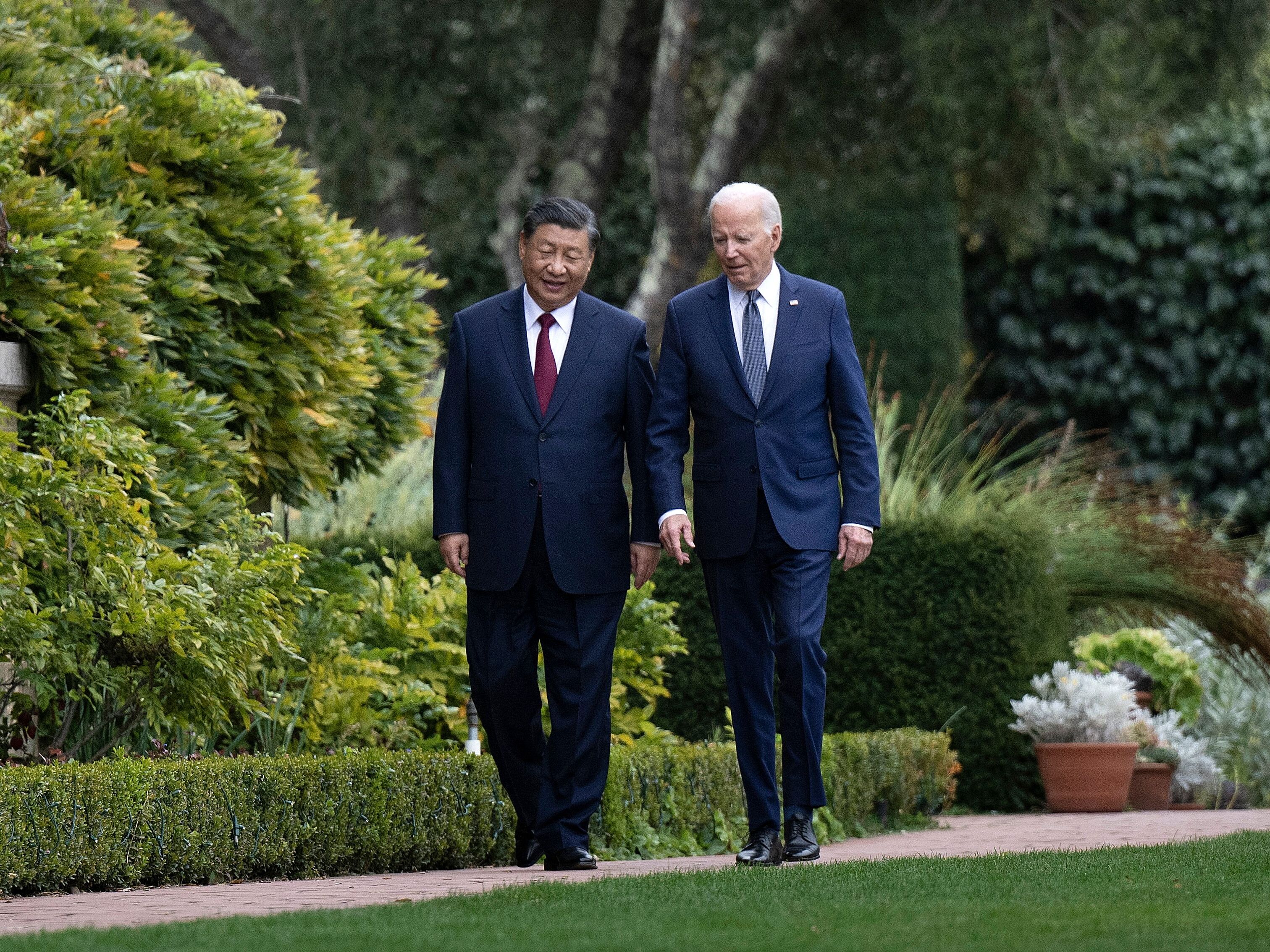 caption:  US President Joe Biden (R) and Chinese President Xi Jinping walk together after a meeting in California last November.  White House officials say that meeting has led to better cooperation on fentanyl interdiction, but some experts are skeptical.