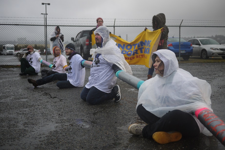 caption: Maru Mora Villalpando, far right, joins a 2014 protest outside the Northwest Detention Center in Tacoma. 