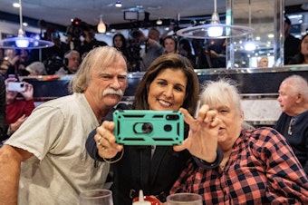 caption: Former U.N. ambassador and 2024 Republican presidential hopeful Nikki Haley takes a selfie with voters at Mary Anne's Diner in Amherst, N.H.