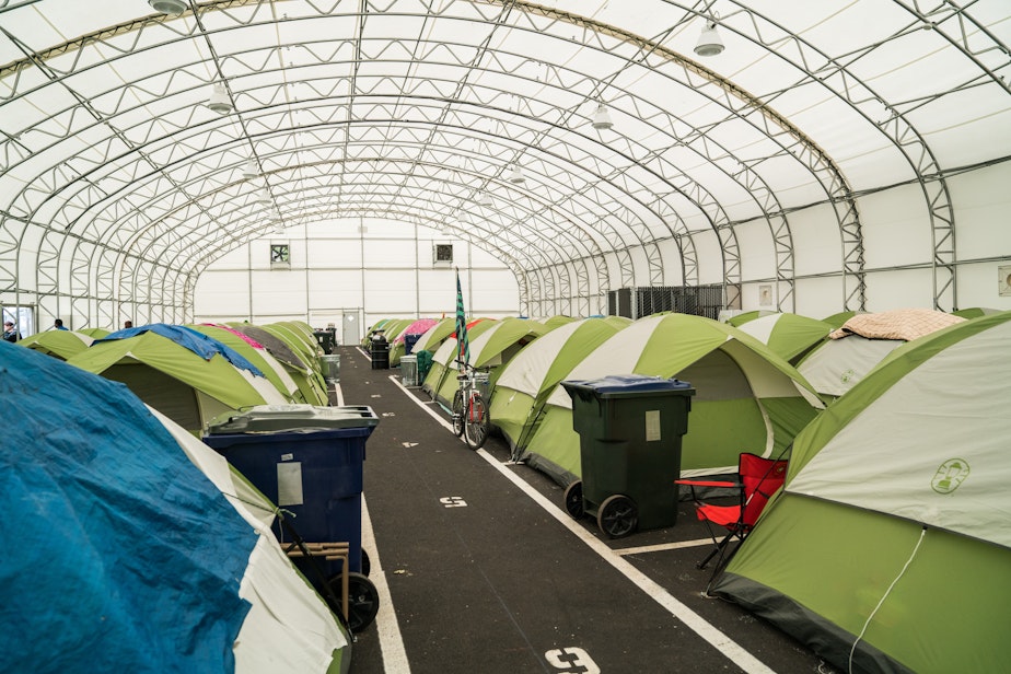 caption: Inside the mega tent set up by the City of Tacoma after declaring a state of public health emergency