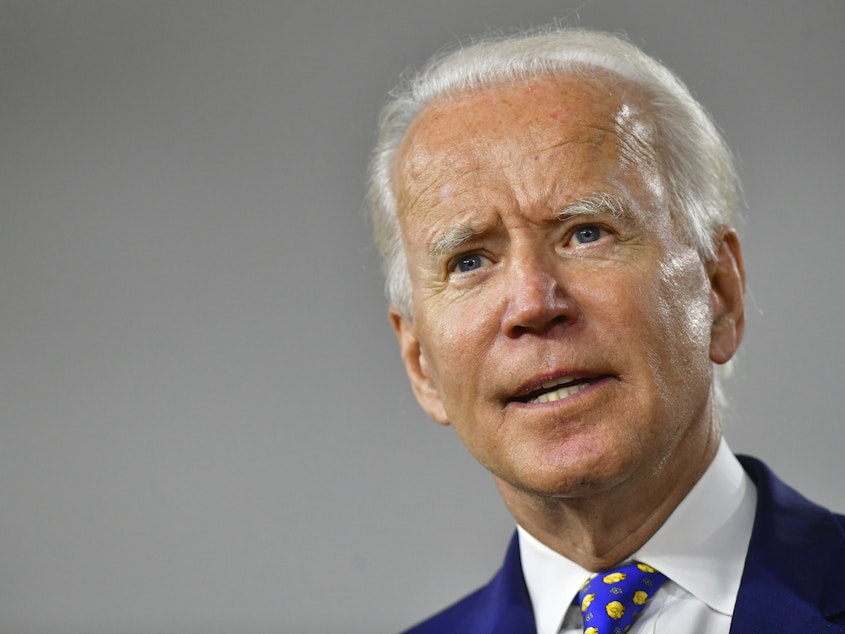 caption: Presumptive Democratic presidential nominee former Vice President Joe Biden delivers a speech in Wilmington, Del., on July 28. The campaign announced Wednesday he would not travel to Milwaukee for the Democratic convention.