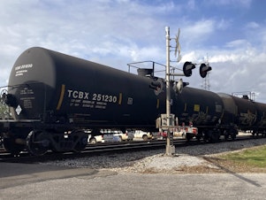 caption: A freight train rolls through Bay St. Louis. April 27, 2021.