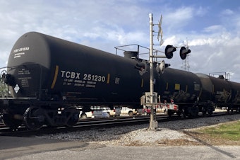 caption: A freight train rolls through Bay St. Louis. April 27, 2021.