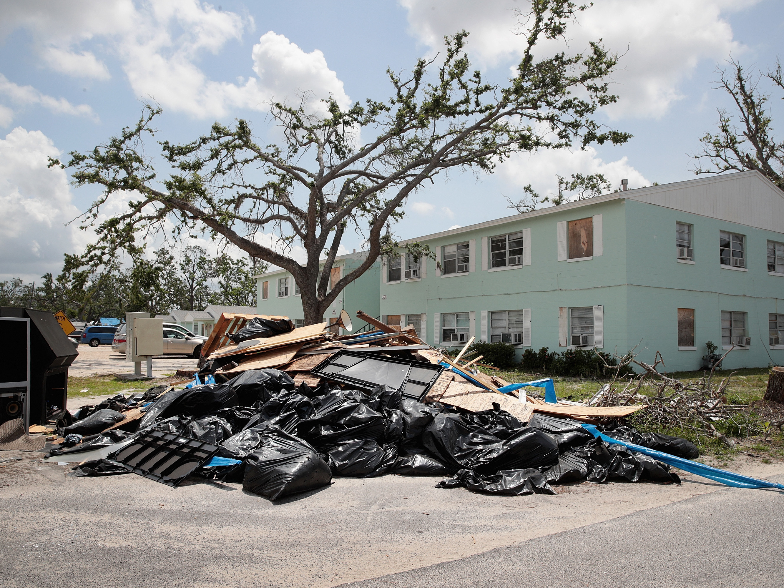 caption: Debris is piled on May 10 outside an apartment complex that was damaged by Hurricane Michael in Panama City, Fla. Rep. Chip Roy objected to a procedural vote on a bipartisan $19.1 billion disaster aid bill, forcing Congress to wait until June to finish work on the legislation.