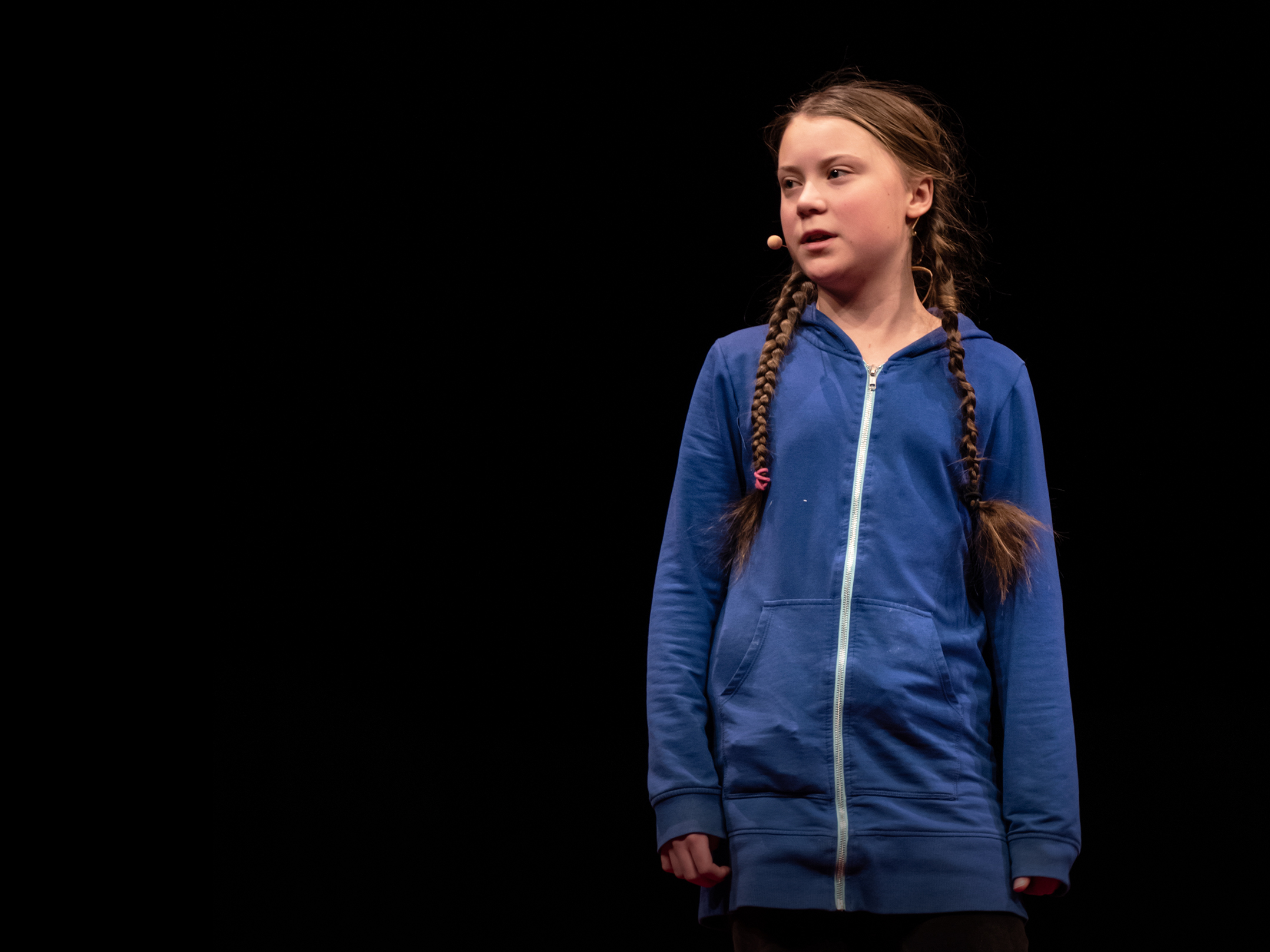 caption: Greta Thunberg on the TED stage.