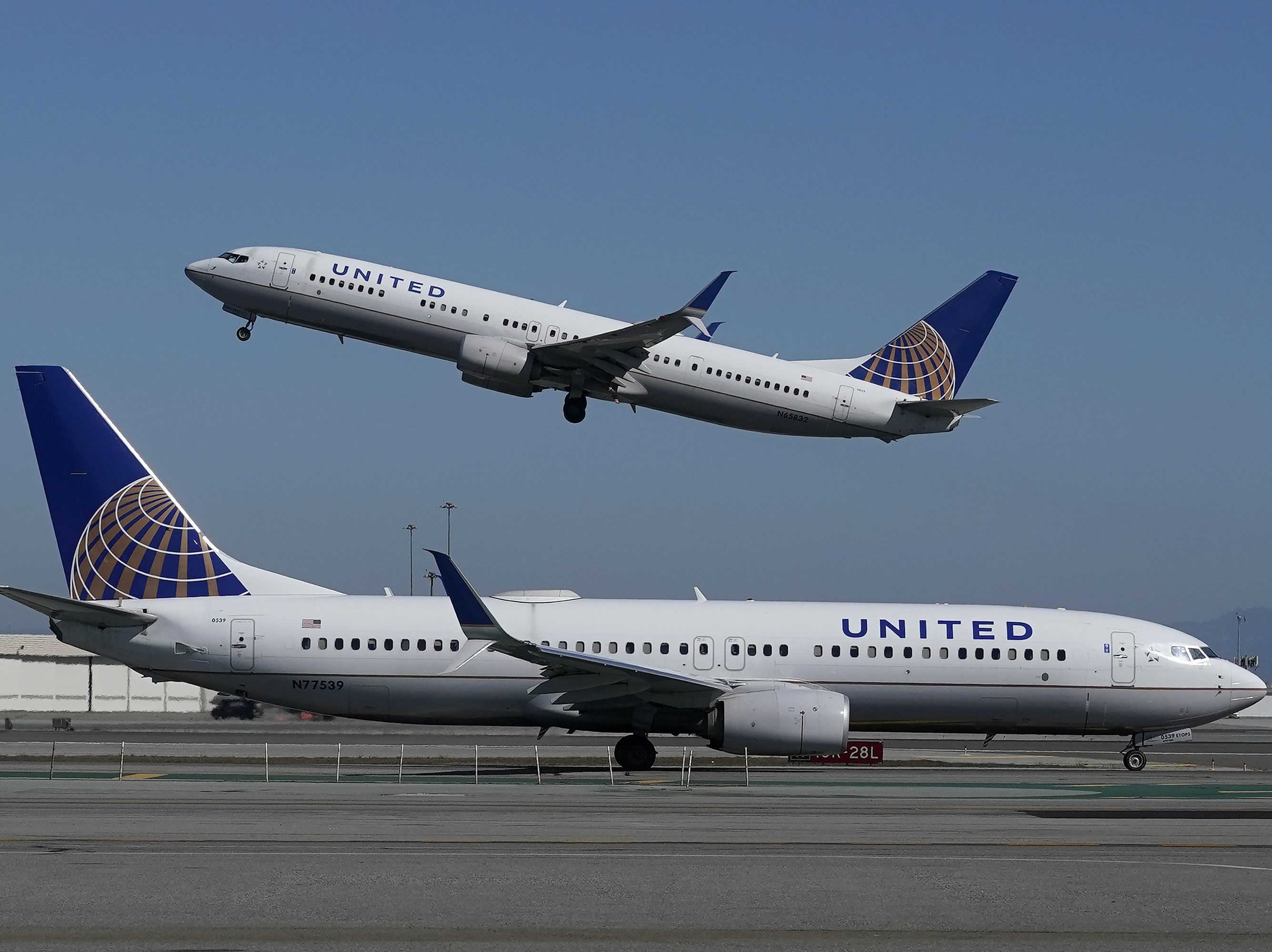 caption: A United Airlines airplane takes off over another plane on the runway at San Francisco International Airport in San Francisco on Oct. 15, 2020. United announced a new order of 270 narrow-bodied planes from Boeing and Airbus.