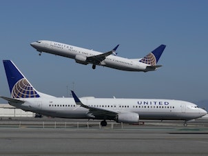 caption: A United Airlines airplane takes off over another plane on the runway at San Francisco International Airport in San Francisco on Oct. 15, 2020. United announced a new order of 270 narrow-bodied planes from Boeing and Airbus.