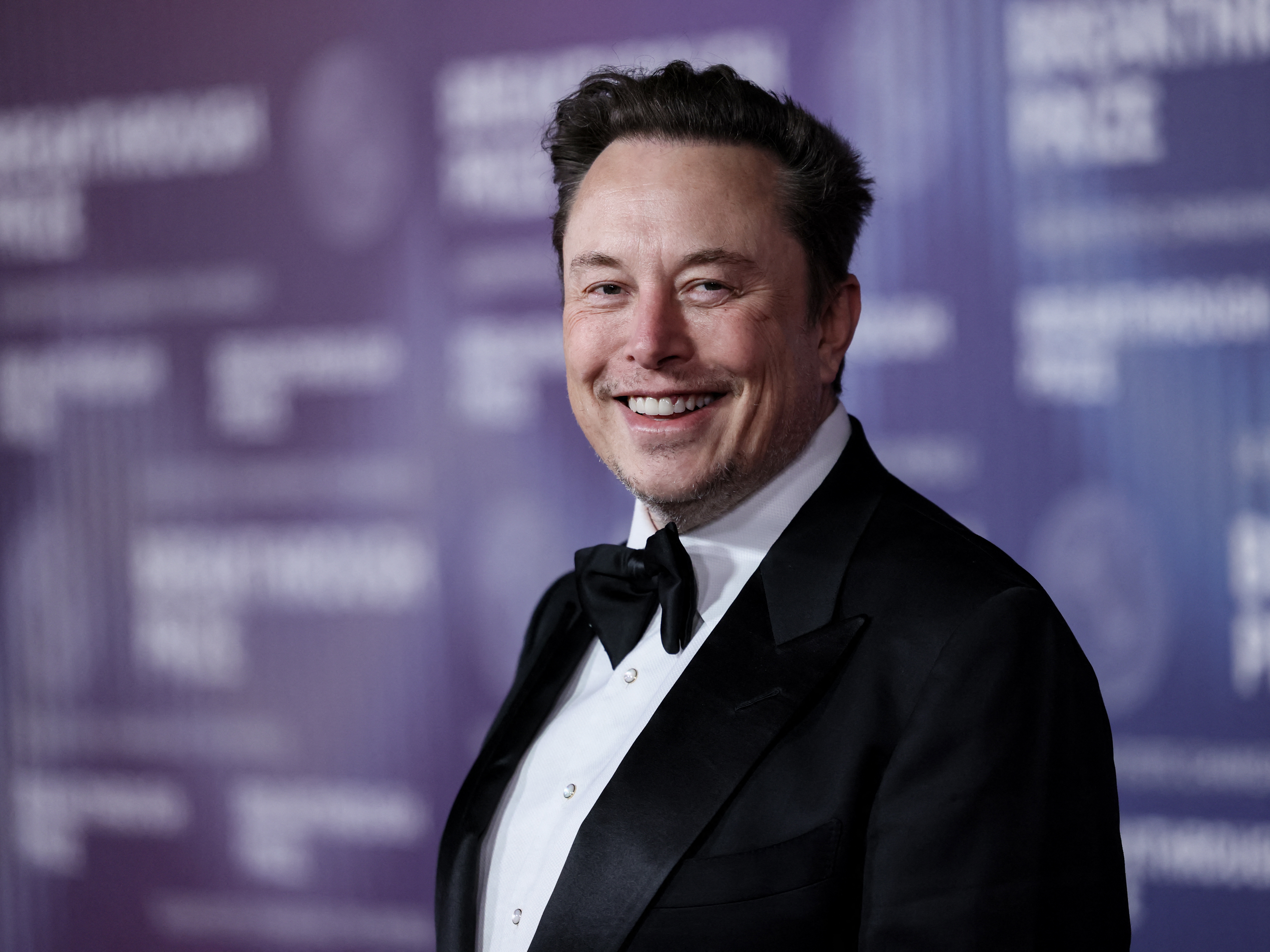 caption: Elon Musk arrives at the Tenth Breakthrough Prize Ceremony at the Academy Museum of Motion Pictures in Los Angeles, California, on April 13, 2024. Tesla shareholders vote Thursday on a pay package that could award Musk a trillion dollars' worth of Tesla stock if he meets certain targets.