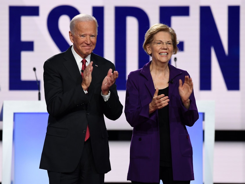 caption: Former Vice President Joe Biden and Massachusetts Sen. Elizabeth Warren appear before a Democratic primary debate in Ohio last year.
