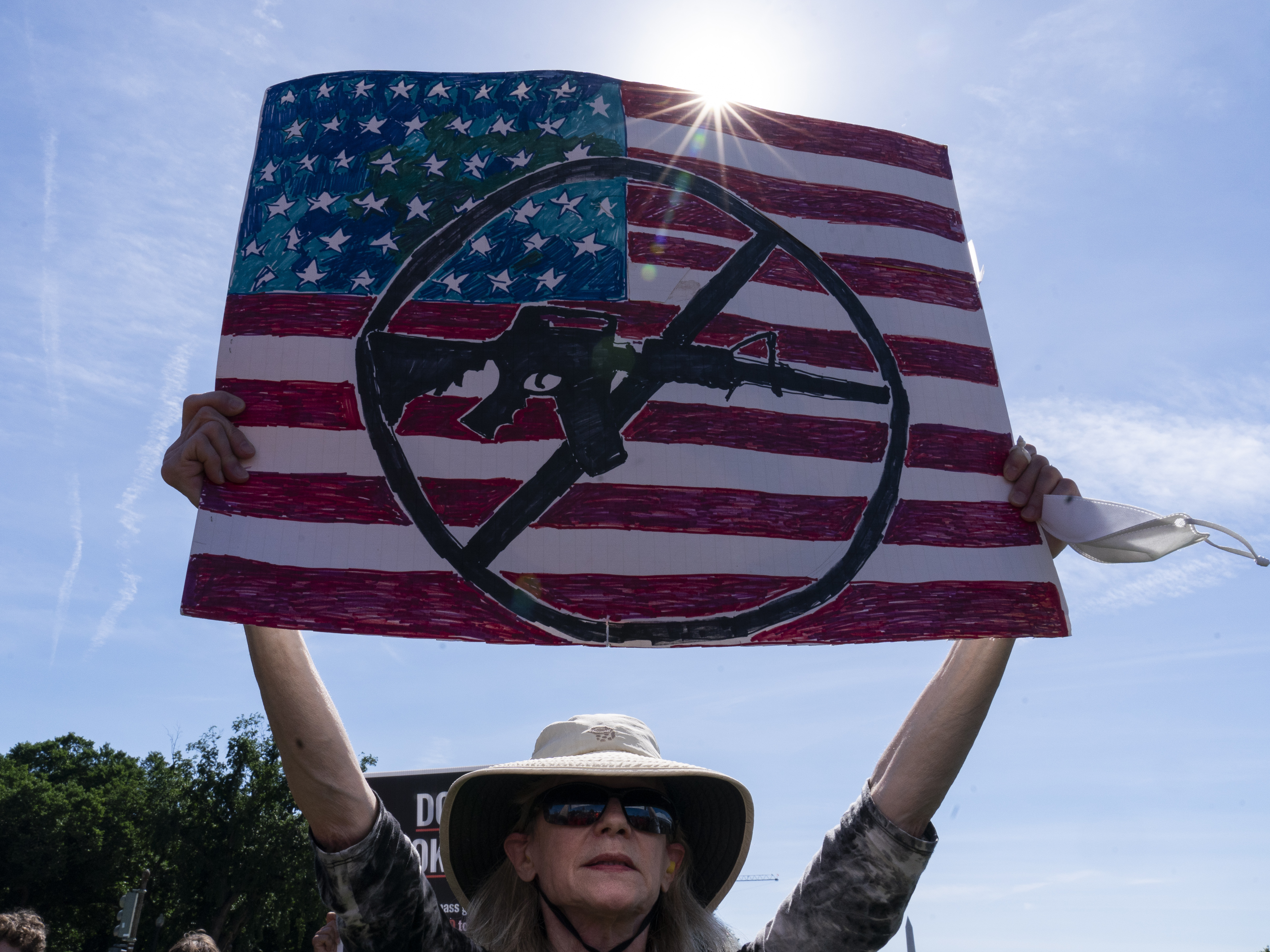 caption: FILE - A protestor holds a sign during a Students Demand Action event, near the U.S. Capitol, Monday, June 6, 2022, in Washington.