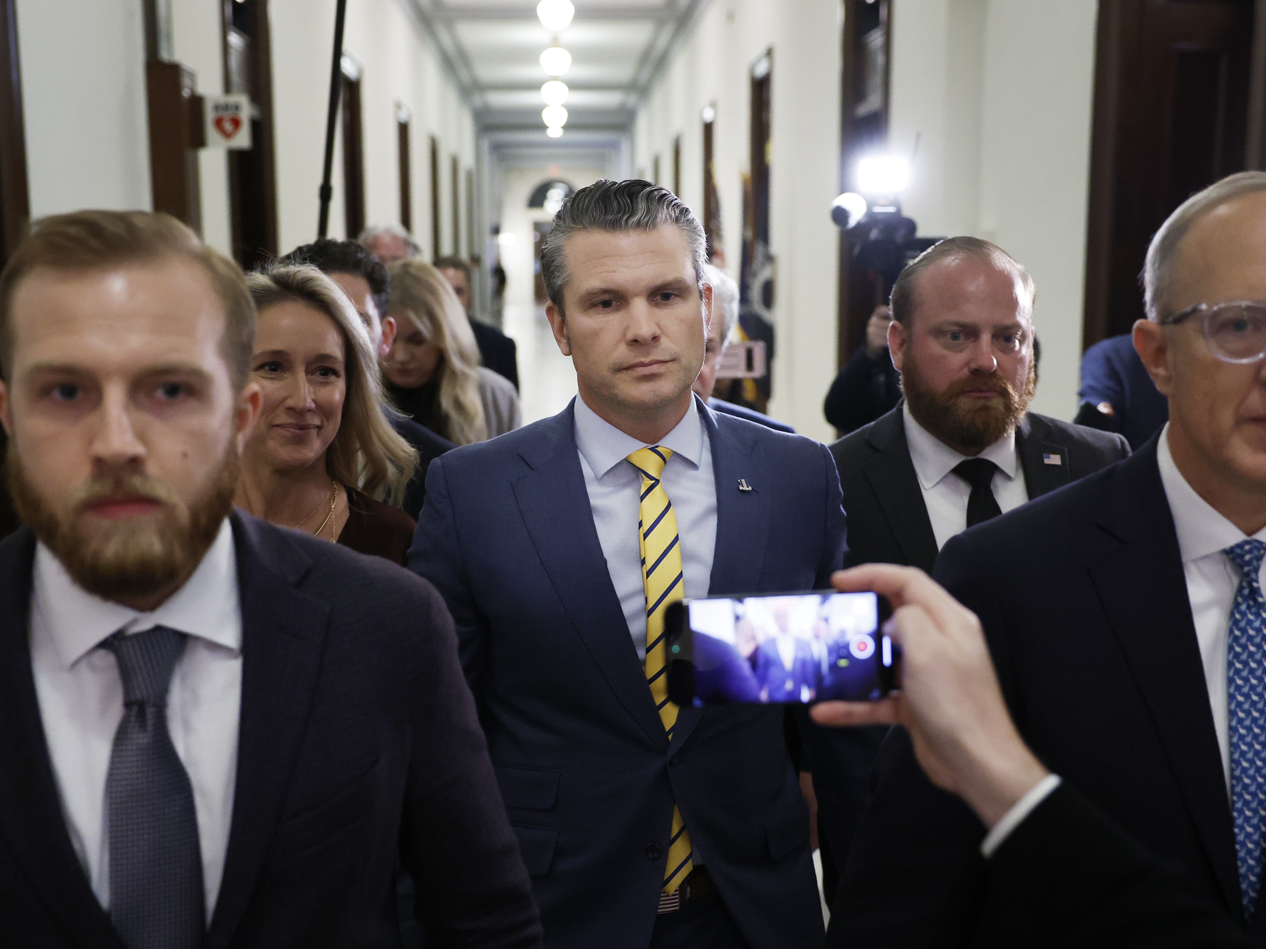 caption: Pete Hegseth, President-elect Donald Trump's nominee to be Secretary of Defense, and his wife Jennifer Rauchet walk through the Russell Senate Office building on Capitol Hill on Dec. 3, 2024.