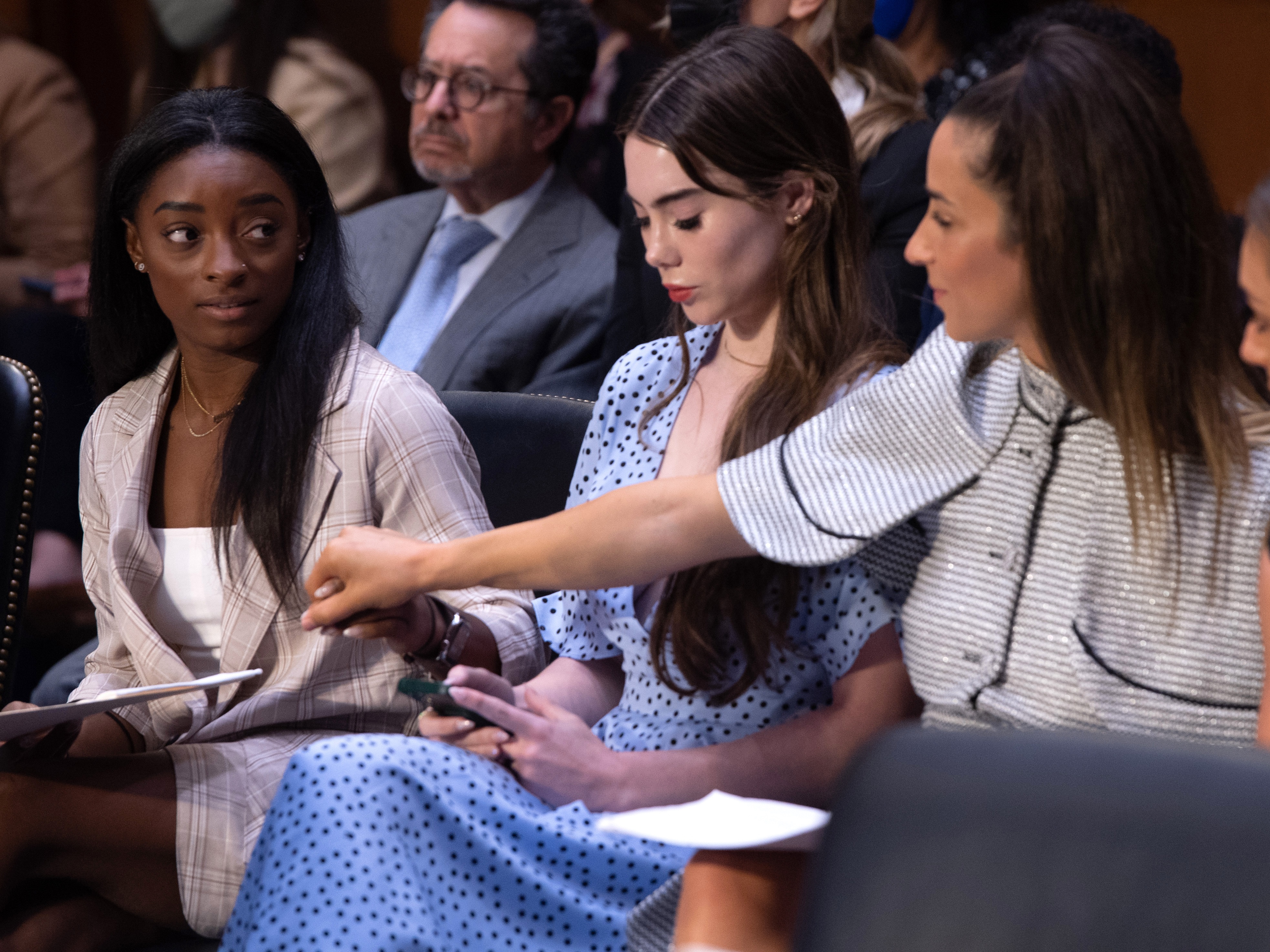 caption: US gymnasts including Simone Biles, left, arrive to testify during a Senate Judiciary hearing about a prior Inspector General report on the FBI handling of the Larry Nassar investigation of sexual abuse of Olympic gymnasts in 2021 in Washington, D.C.