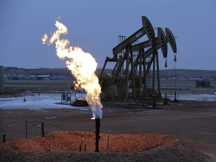 caption: Methane, the main component of natural gas, is also a byproduct of oil drilling.