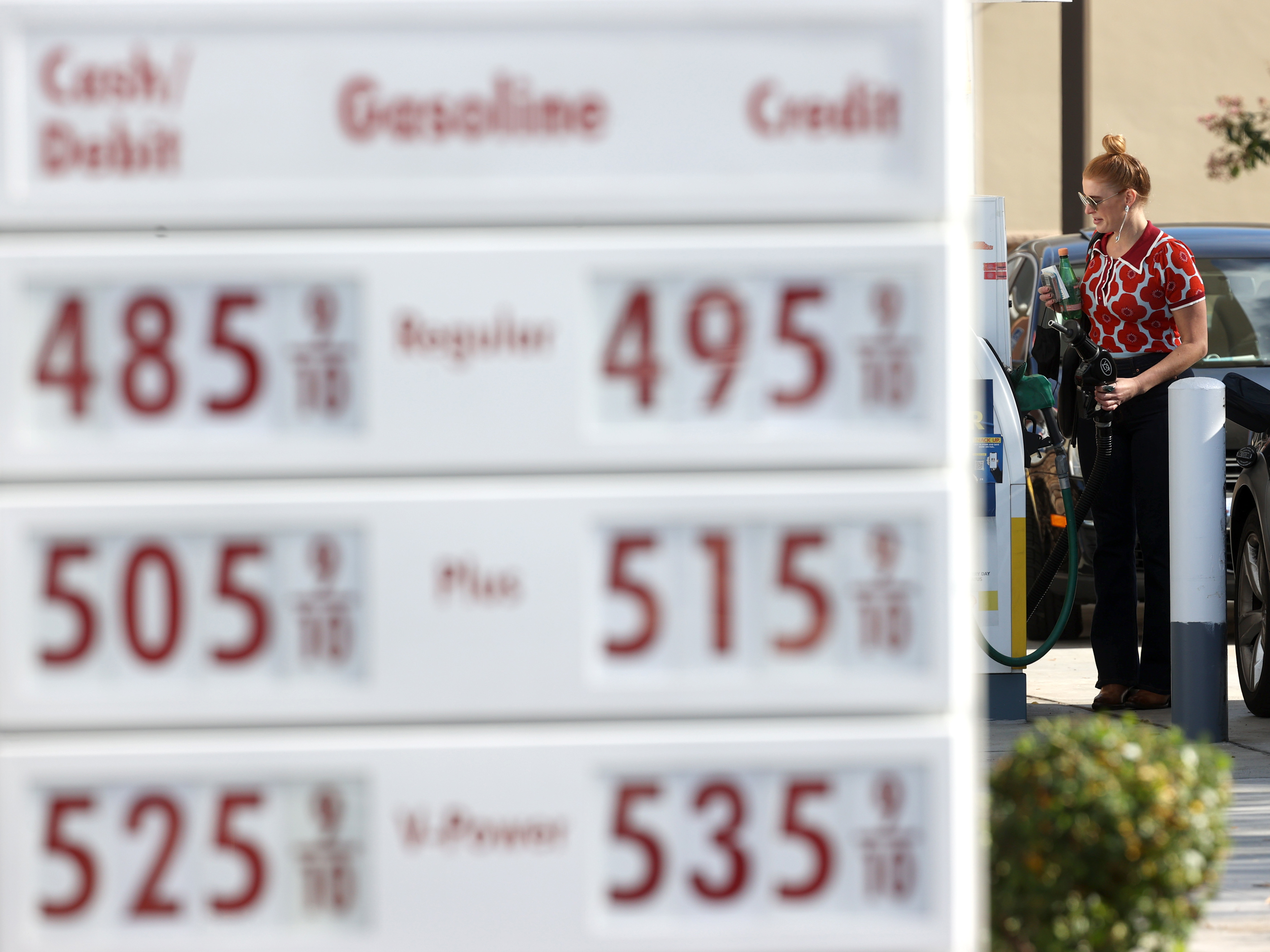 caption: A customer prepares to pump gas into her car at a Shell station on Nov. 17 in San Rafael, Calif. A surge in gas prices this year is leaving the Biden administration looking for options to do something about it. One that's getting recent attention is tapping the country's emergency oil stockpile.