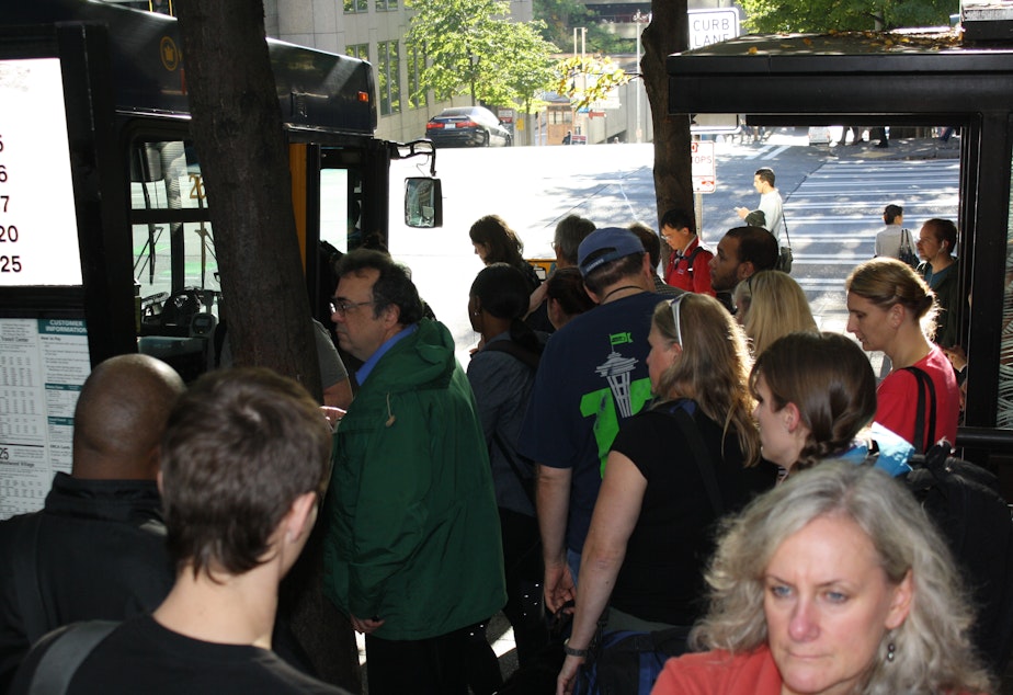 caption: Bus riders are used to competing for the few remaining spaces at the last stop before many West Seattle-bound buses enter the Viaduct. If Proposition 1 passes this November, King County would increase service at congested stops.