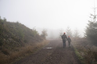 caption: <p>Tyler Tiller and his daughter Taylor walk along a gravel road during the last days of&nbsp;doe season on Oct. 30, 2018 in Drain, Ore.&nbsp;</p>