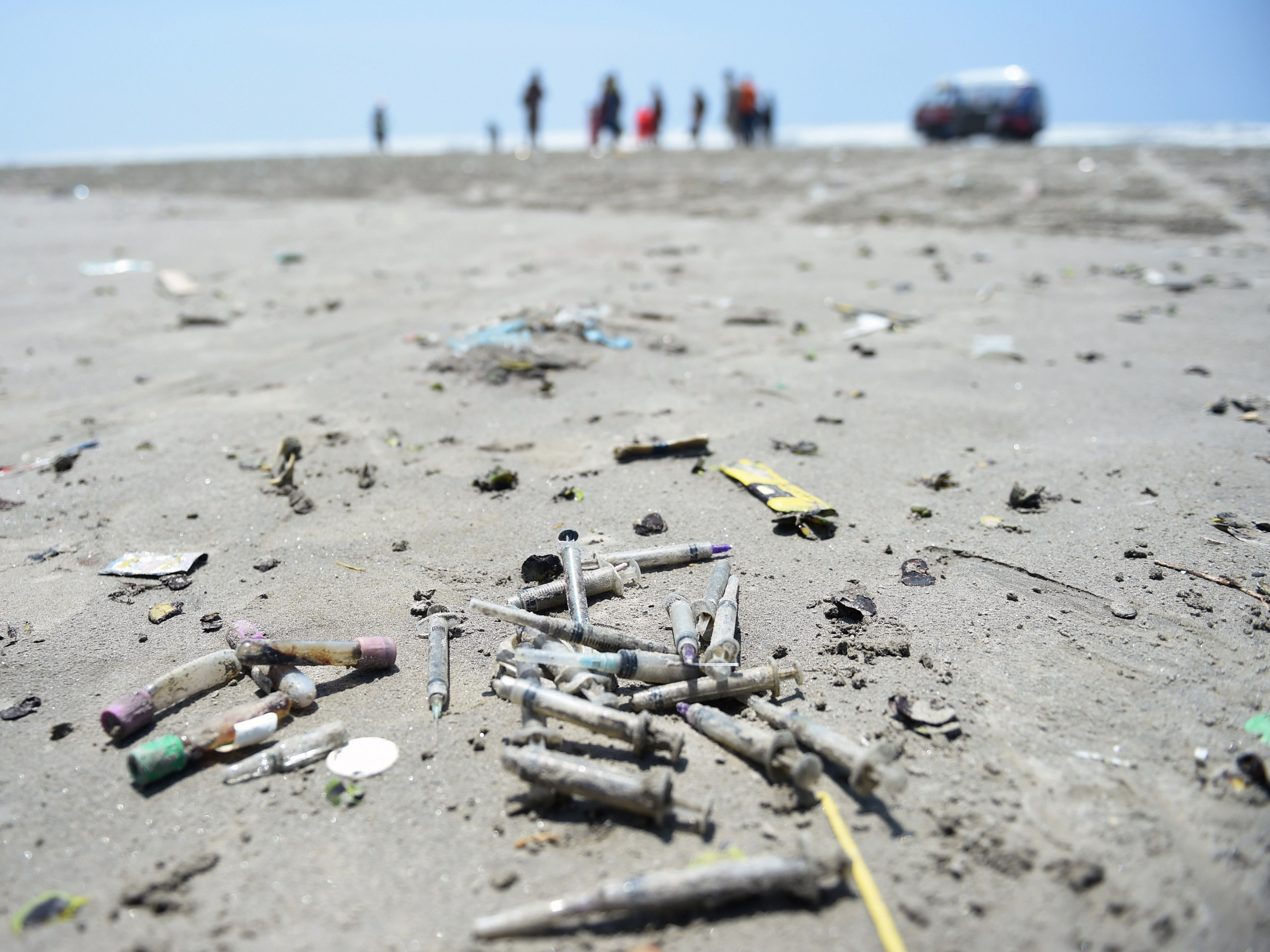 caption: In this picture taken on September 3, 2019 used medical waste is pictured on Clifton beach in Karachi. - Swarms of flies, water-borne illnesses, and rivers of sewage have brought Pakistan's Karachi to its knees this rainy season as decades of mismanagement have turned the countrys commercial capital into a post-apocalyptic wasteland.