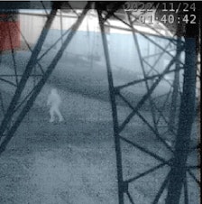 caption: An infrared image from about 1:40 a.m. on Nov. 24, 2022, shows a person running beneath a transmission tower inside a Bonneville Power Administration substation in Oregon City, Oregon. 