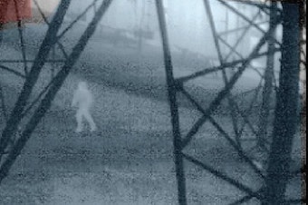 caption: An infrared image from about 1:40 a.m. on Nov. 24, 2022, shows a person running beneath a transmission tower inside a Bonneville Power Administration substation in Oregon City, Oregon. 