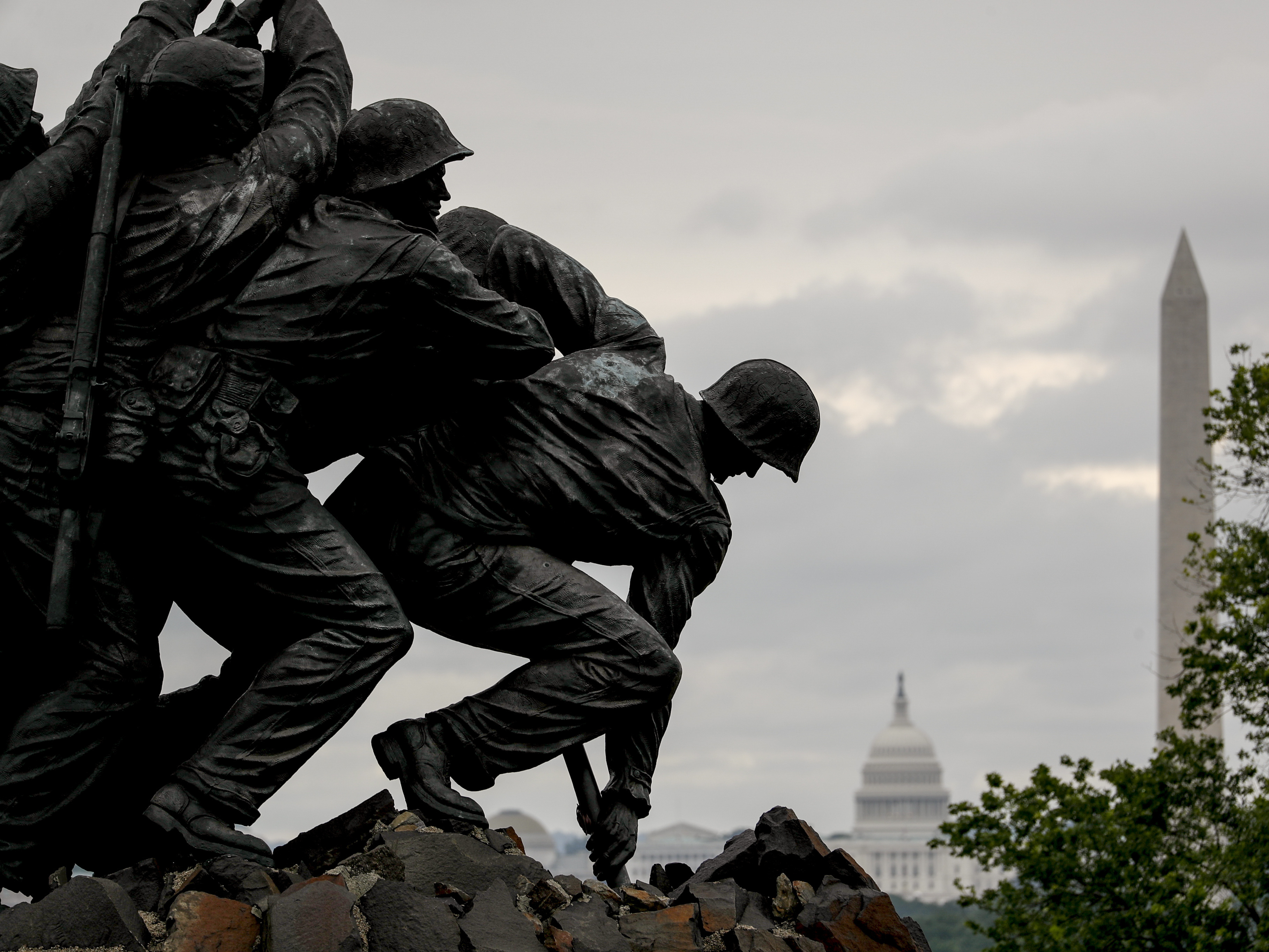 caption: The Washington Monument and the dome of the U.S. Capitol Building are visible behind the U.S. Marine Corps War Memorial in Arlington, Va., on Memorial Day.