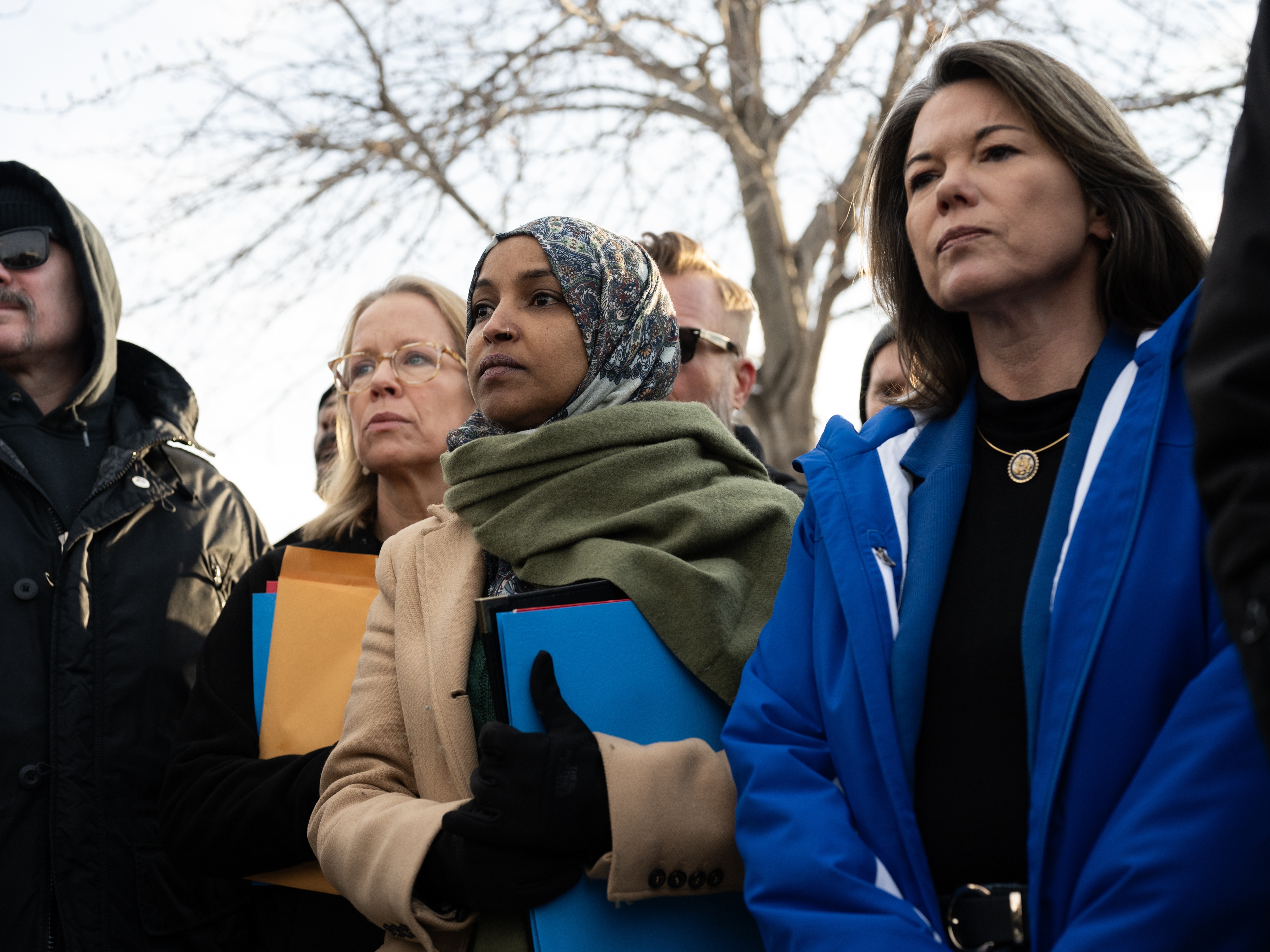 caption: U.S. Rep. Ilhan Omar, joined by Rep. Kelly Morrison (L) and Rep. Angie Craig (R) arrive outside of the regional ICE headquarters at the Whipple Federal Building on Saturday in Minneapolis. The Democratic congresswomen were granted access to the facility initially, but were quickly asked to leave by officials there.