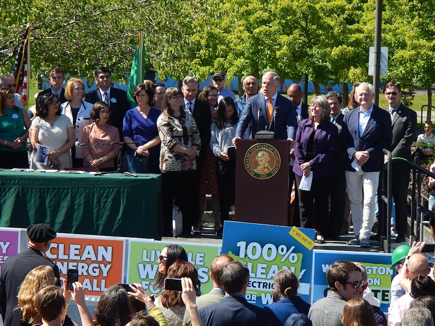 caption: Washington Gov. Jay Inslee at a signing ceremony for five climate bills on Tuesday in Seattle.