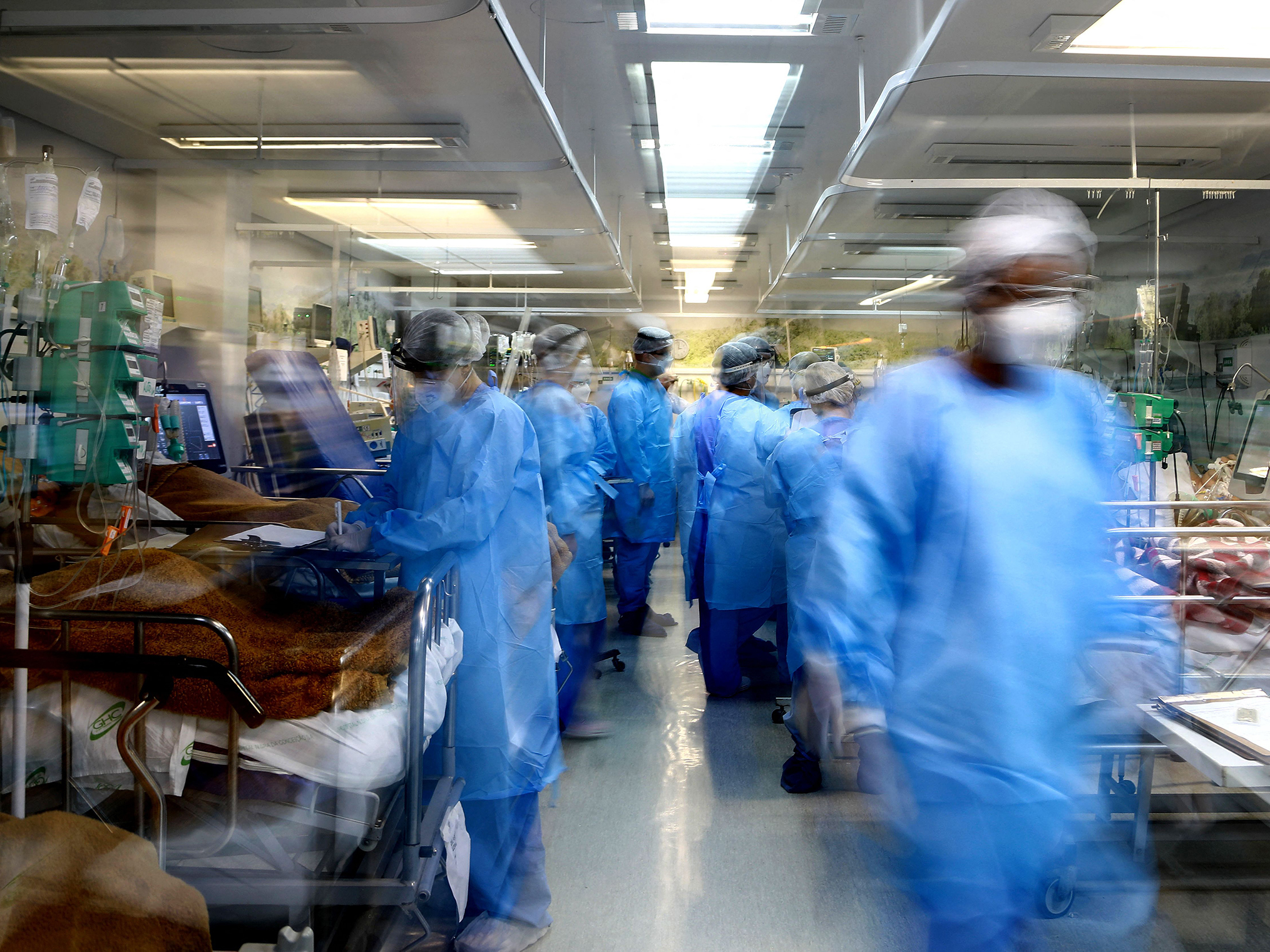 caption: Health workers care for COVID patients at the emergency room of the Nossa Senhora da Conceição hospital on March 11. In more than half of Brazil's 26 states, ICU occupancy rates have hit 90% or above during the pandemic.