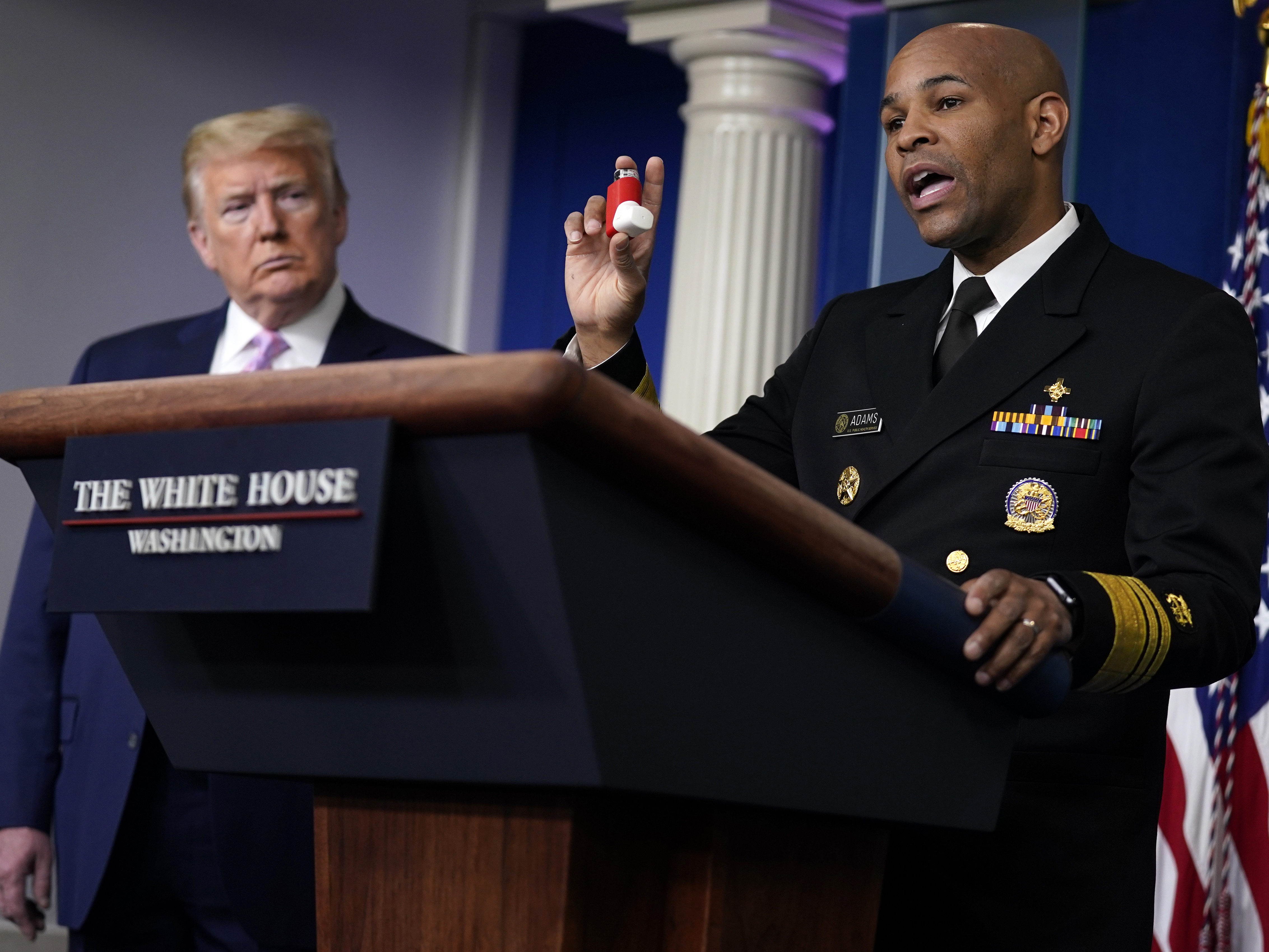 caption: Surgeon General Jerome Adams shows his inhaler during a coronavirus task force briefing at the White House at which he made a personal appeal to communities of color to follow federal guidelines.