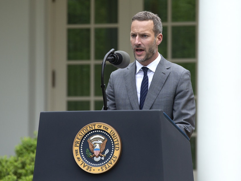 caption: Adam Boehler, chief executive officer of U.S. International Development Finance Corporation (DFC), speaks at the White House in April.