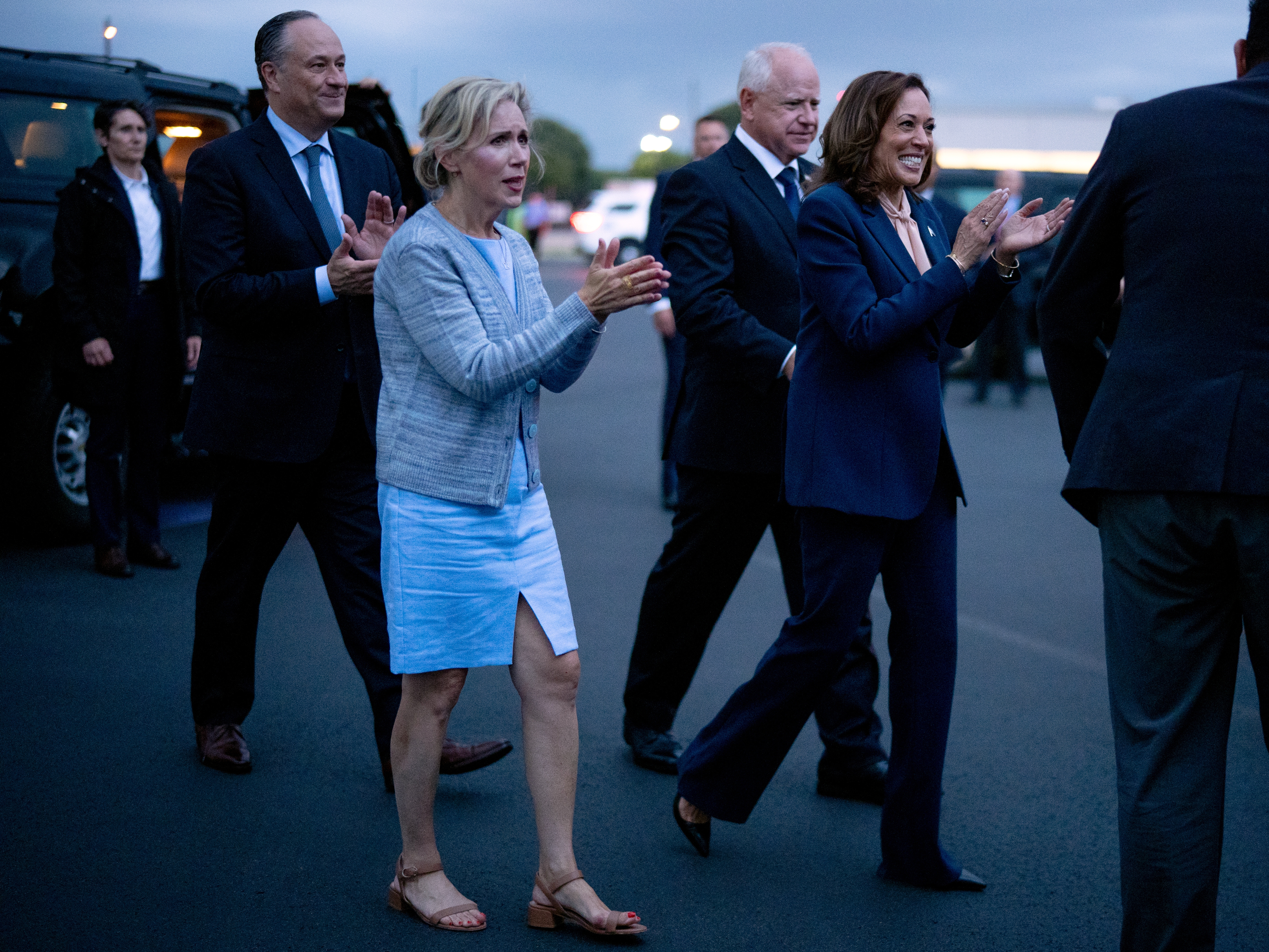 caption: Second gentleman Doug Emhoff, Gwen Walz, vice presidential candidate Tim Walz and presidential candidate Kamala Harris walk across the tarmac at Philadelphia International Airport after their first rally together on Tuesday. 