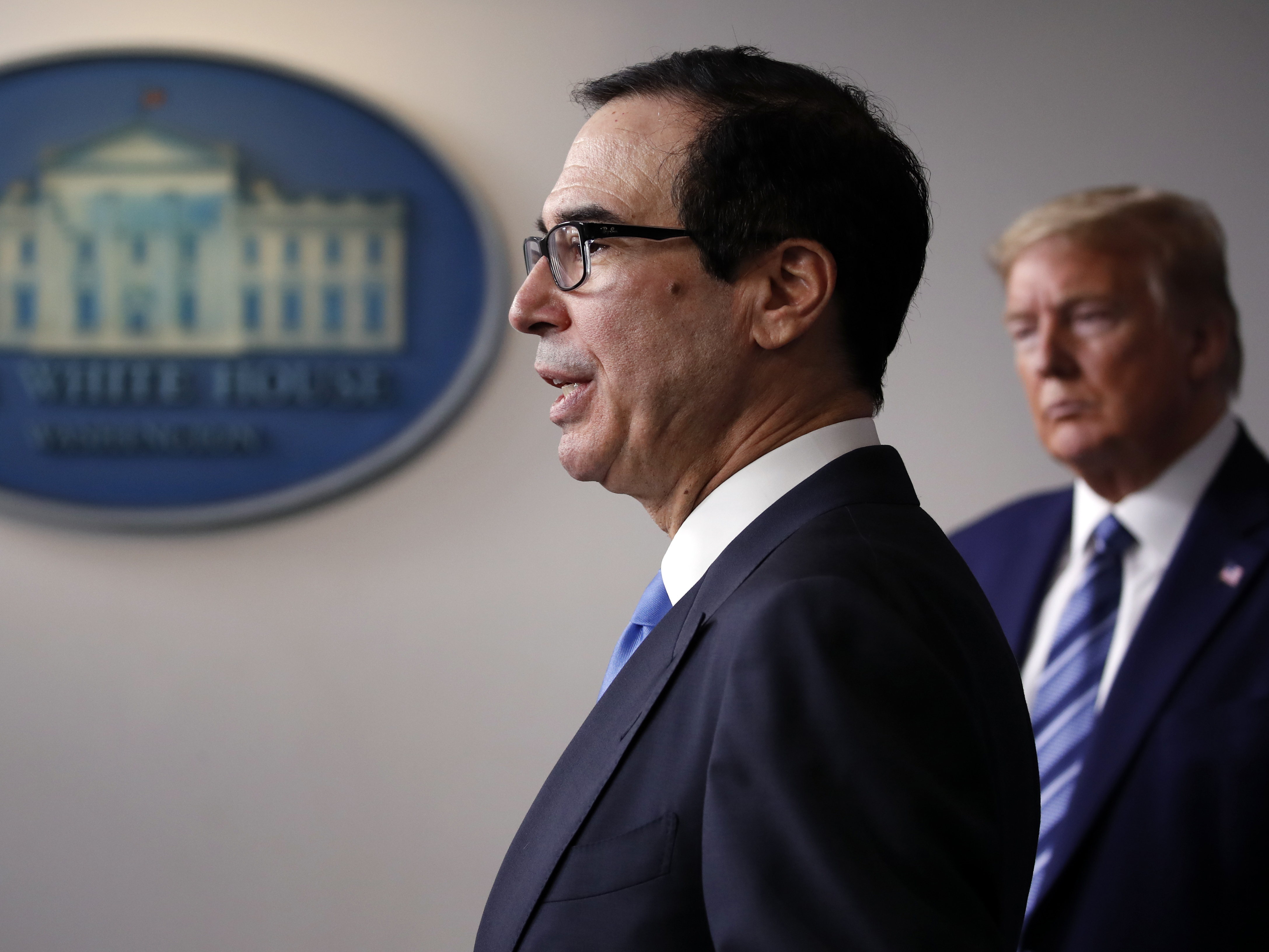 caption: Treasury Secretary Steven Mnuchin speaks at a White House coronavirus press briefing in April.