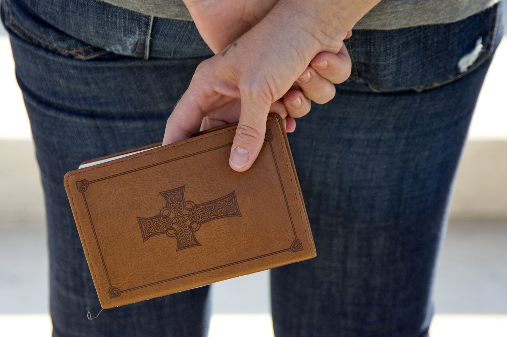 caption: A woman holds a bible as she prays on the front steps of the Supreme Court in Washington, Monday, Oct. 1, 2012. (Carolyn Kaster/AP)