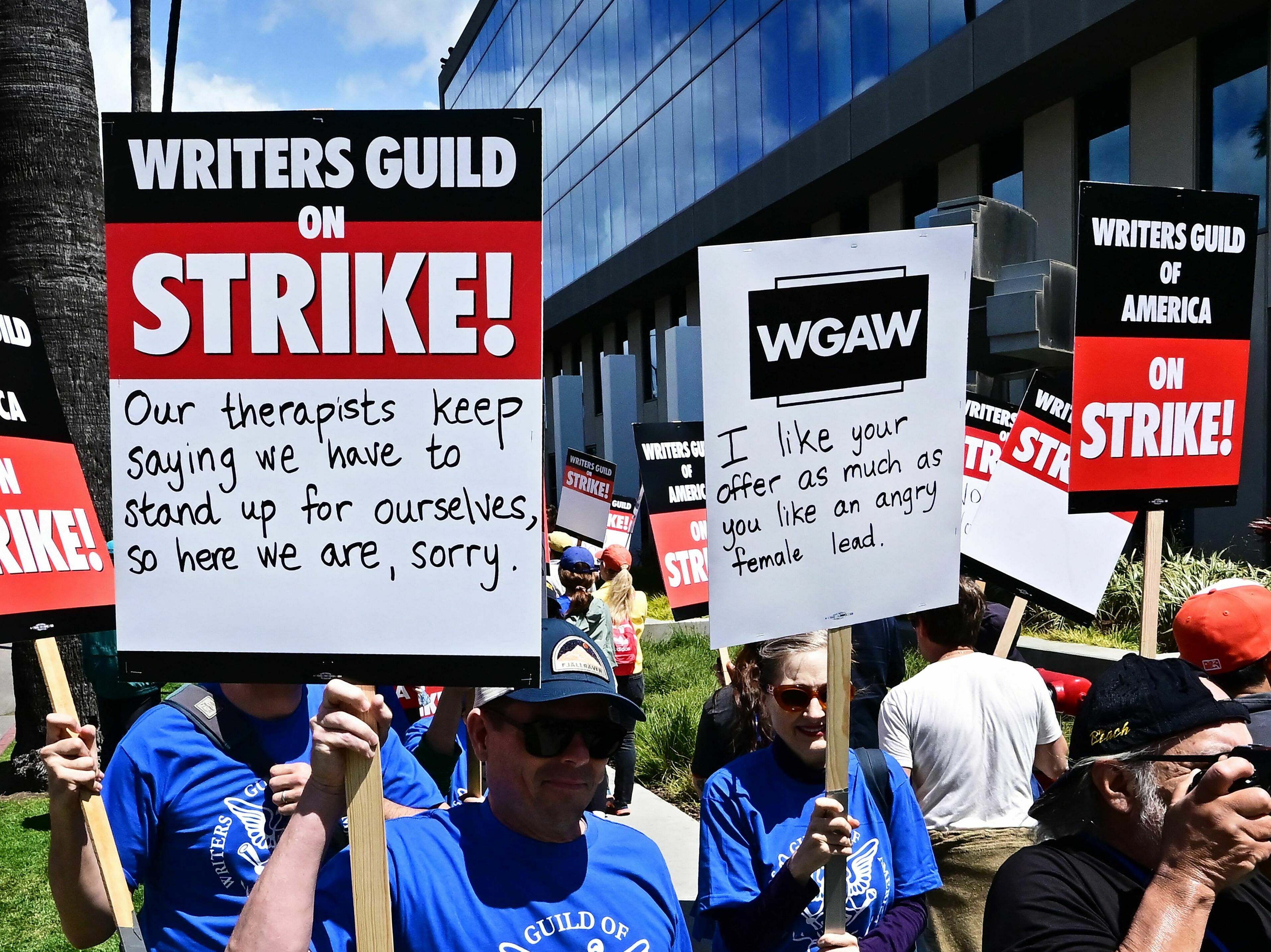 caption: Writers picket in front of Netflix offices in Hollywood on Tuesday as the WGA strike began.