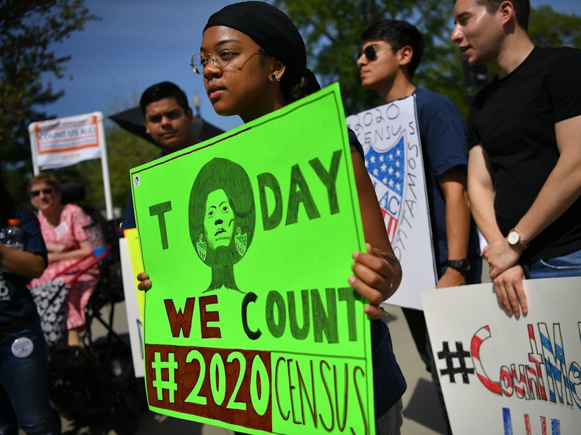 caption: Demonstrators against a proposal to add a citizenship question to the 2020 census protest outside the U.S. Supreme Court in Washington, D.C., in April.