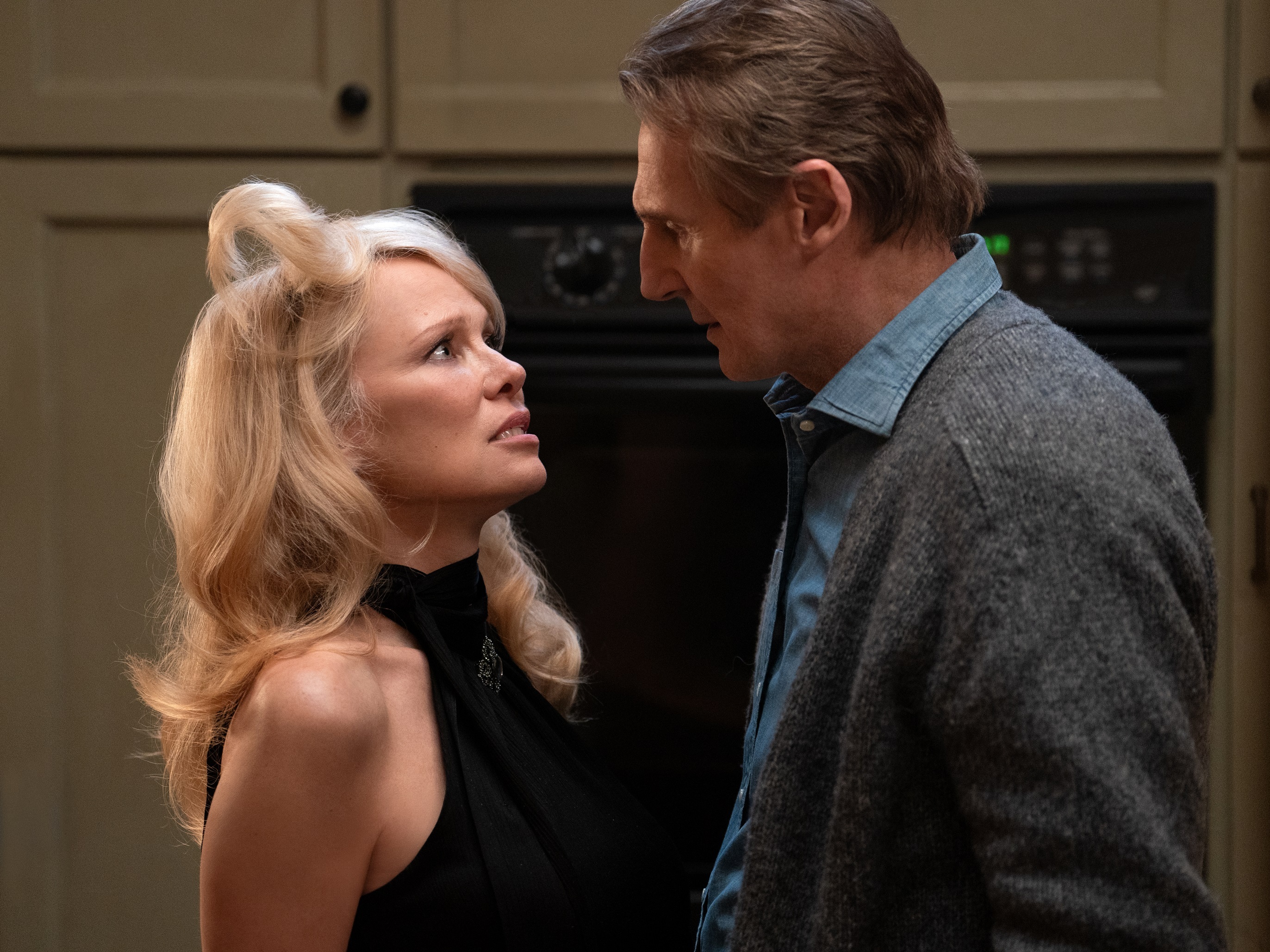 caption: Pamela Anderson plays Beth Davenport and Liam Neeson is Frank Drebin Jr.  in<em> The Naked Gun. </em>