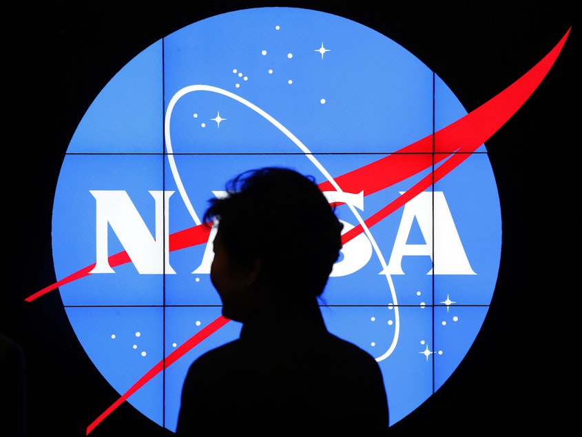 caption: South Korean President Park Geun-hye walks past a NASA logo during a tour at the agency's Goddard Space Flight Center in Greenbelt, Md.