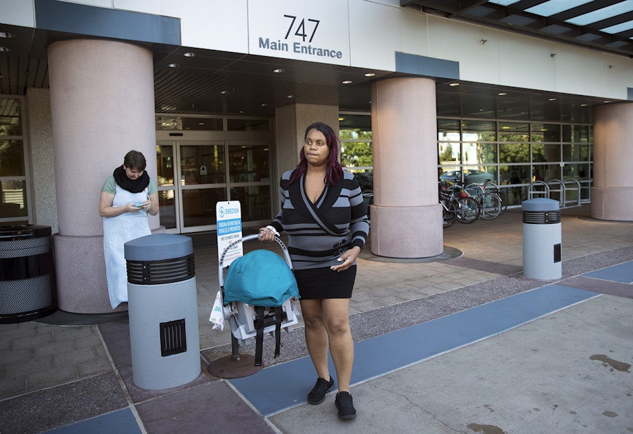 caption: Tiffany Hicks carries her newborn son, Elijah, as she leaves Swedish First Hill Birth Center on Thursday, August 31, 2017, in Seattle. 