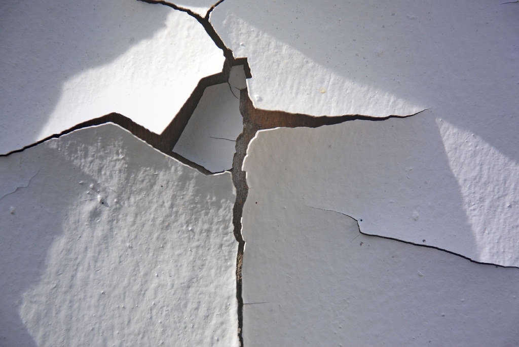 caption: Chipping paint is a lead poisoning danger to kids.