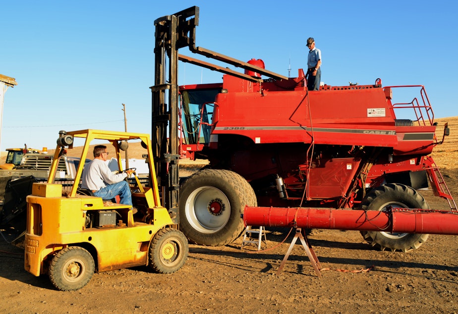 caption: Chris Shaffer, at left, and his father, Monte Shaffer, work on a wheat combine with mechanical problems. Chris Shaffer says that if dams are removed on the Snake River, 'There's gonna be a whole bunch of people that aren't going to farm wheat anymore.'