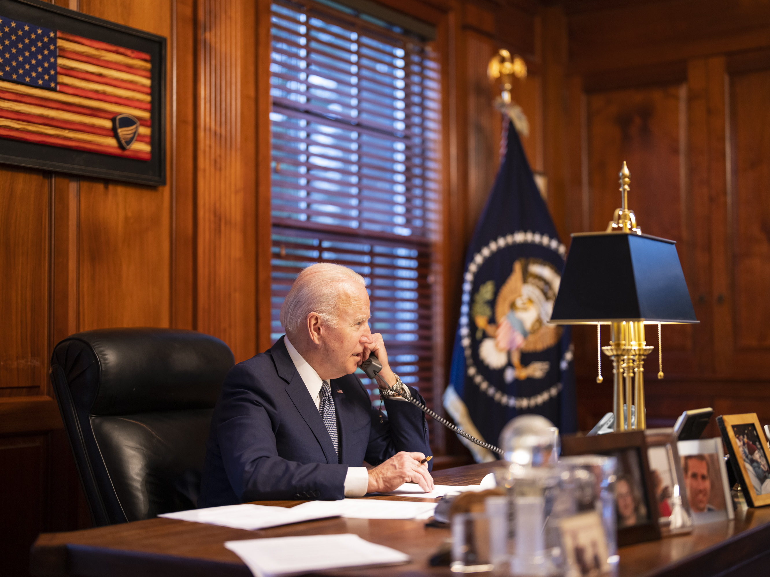 caption: In this image provided by the White House, President Biden speaks with Russian President Vladimir Putin on the phone from his private residence in Wilmington, Del., on Thursday.