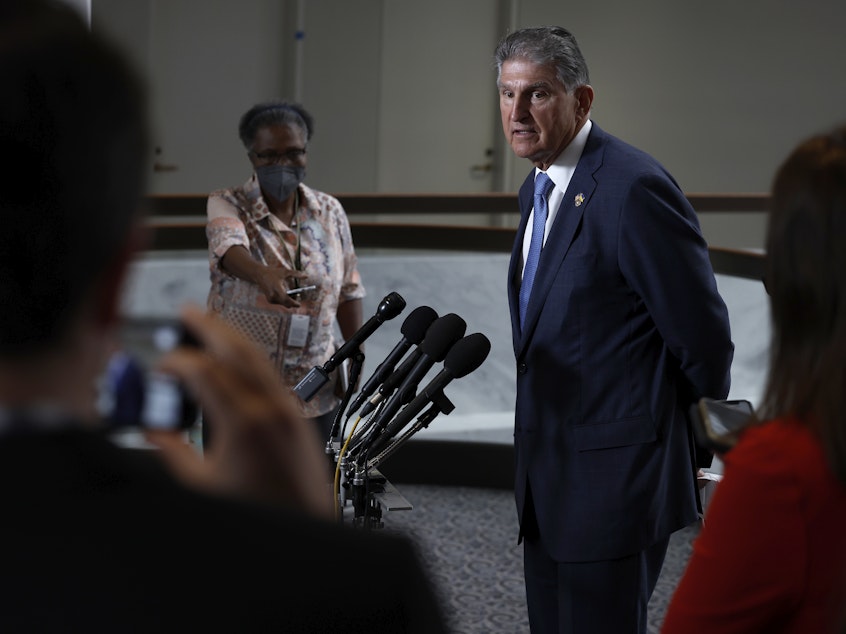 caption: Sen. Joe Manchin, Democrat of West Virginia, speaks to reporters about the compromise bill that could substantially alter a tax provision called the "carried interest loophole."
