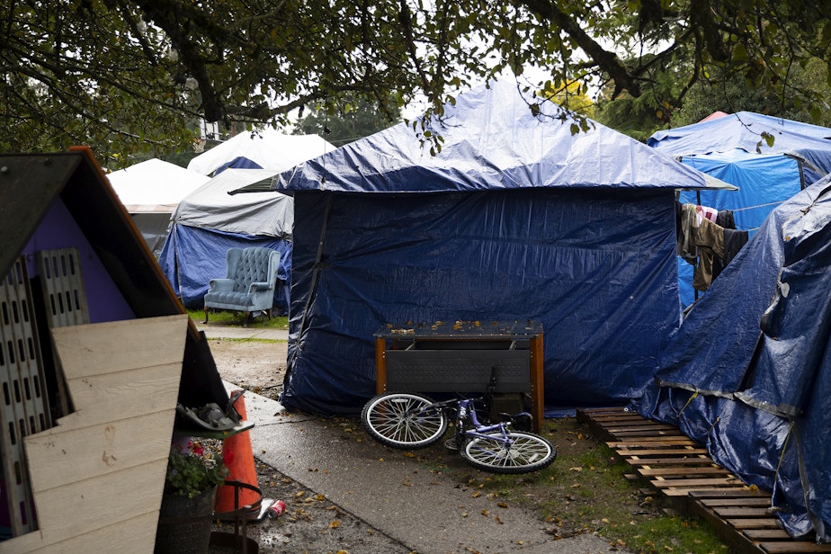 caption: Tents are shown on Monday, October 16, 2023, at Riverton Park United Methodist Church, where nearly 200 people are sheltering while seeking asylum, in Tukwila. 