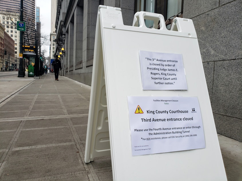 caption: Signs outside the 3rd Avenue entrance to the King County Courthouse direct people to the other entrance around the block.