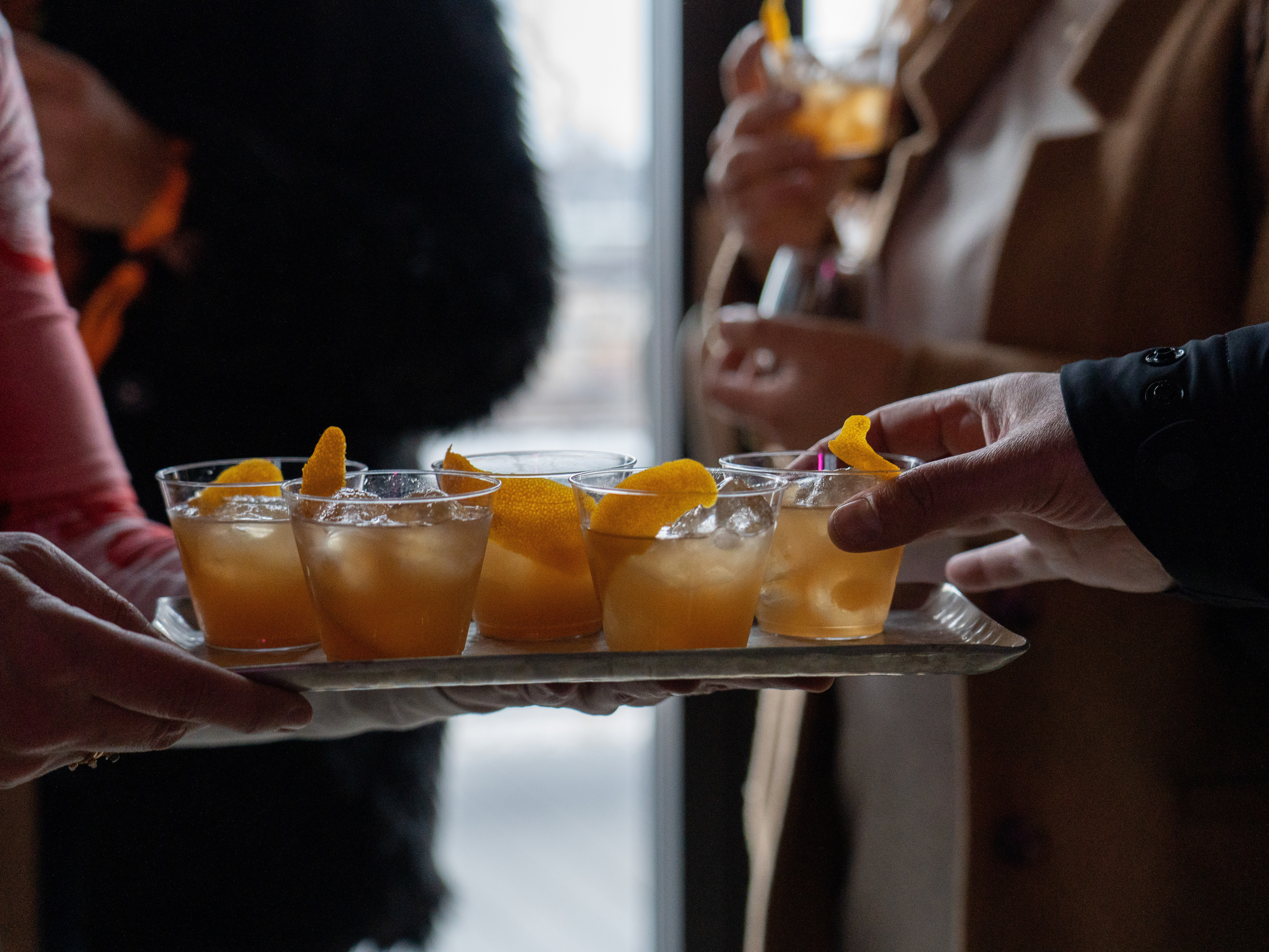 caption: People enjoy nonalcoholic old fashioned cocktails from a recipe by mixologist Derek Brown during the Mindful Drinking Fest in Washington, D.C., on Jan. 21.