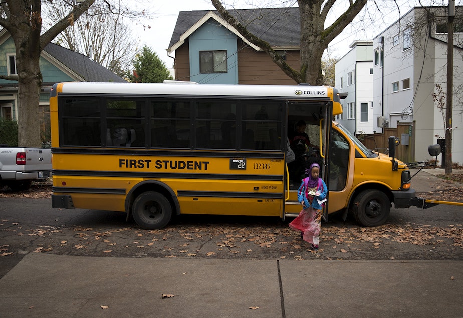 caption: Biftu Aliya, 9, gets off of the school bus on Thursday, November 15, 2018, at her home in Seattle. Tap or click on the first image to see more. 