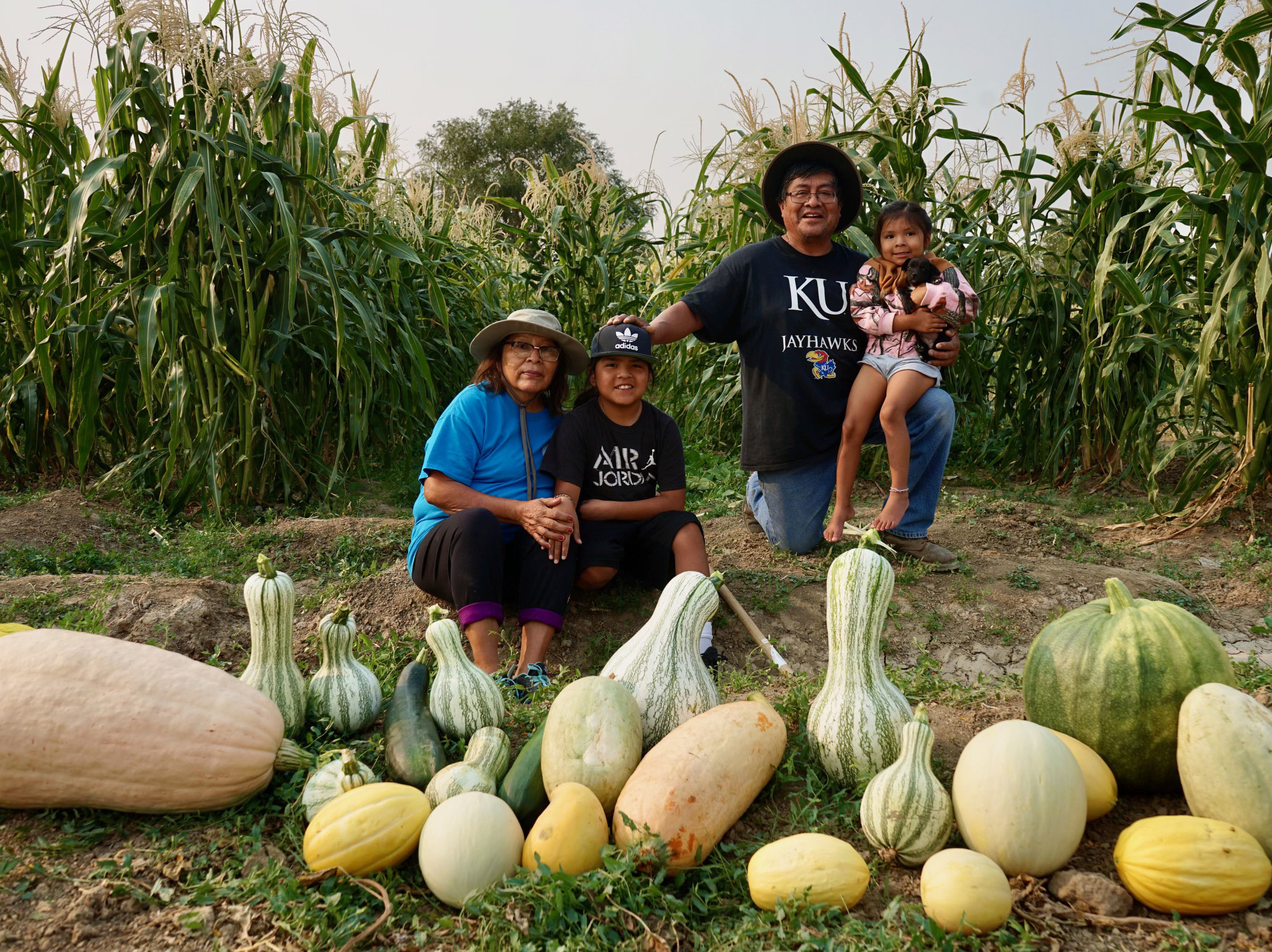caption: Native tribes have responded to the pandemic with creative ways to stay connected. Veronica Concho and Raymond Concho Jr. grew traditional Pueblo foods and Navajo crops with their grandchildren Kaleb and Kateri Allison-Burbank in Waterflow, N.M.